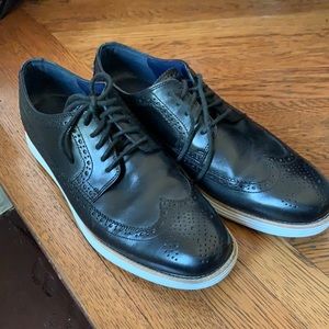 Cole Haan Black leather with white bottoms.